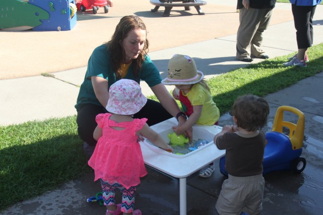 Sierra Butzler, child and youth program assistant, helps toddlers with a water activity Aug. 8, 2017, at Fort McCoy, Wis. The Fort McCoy CDC was recently reaccredited through the National Association for the Education of Young Children, earning...