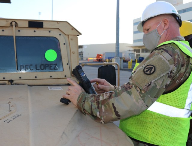 Master Sgt. Louis Burnett hand scans the shipping number for a humvee during port operations at Pearl Harbor in support of 25th Infantry Division return from JRTC on Dec. 5.