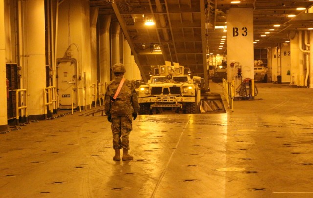 An MRAP drives out of the hold of the USNS Fisher during port operations at Pearl Harbor on Dec. 5.