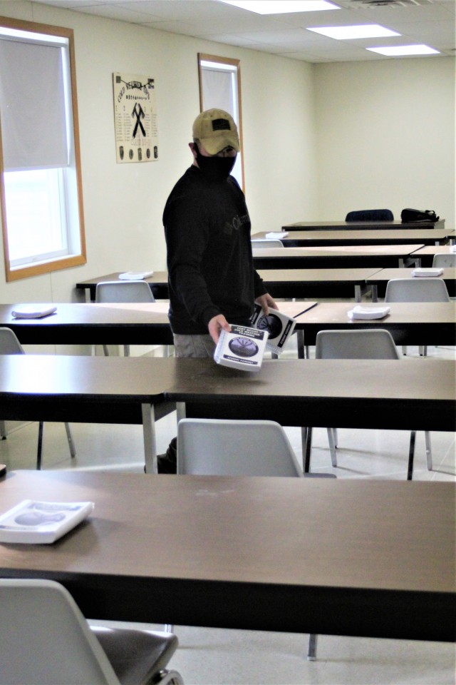 Instructor Joe Ernst sets up a classroom for the Cold-Weather Operations Course (CWOC) training facility Dec. 3, 2020, at Fort McCoy, Wis. CWOC students are trained on a variety of cold-weather subjects, including snowshoe training and skiing as...
