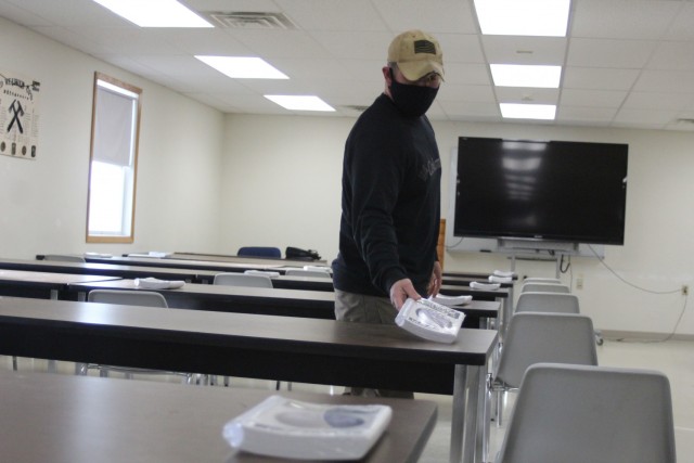 Instructor Joe Ernst sets up a classroom for the Cold-Weather Operations Course (CWOC) training facility Dec. 3, 2020, at Fort McCoy, Wis. CWOC students are trained on a variety of cold-weather subjects, including snowshoe training and skiing as...