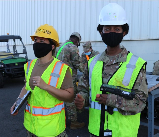 Petty Officer 1st Class Ilene Cerda and Sgt. Nashell Mendez take a short break during their tallying and scanning at Pearl Harbor on Dec. 5.