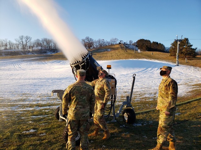Members of the Fort McCoy, Wis., garrison command team operate the snow-making machine Dec. 3, 2020, at Whitetail Ridge Ski Area. Staff members began making snow Dec. 3 for the 2020-21 winter season. (Photo contributed by Scott Abell/Directorate of Family and Morale, Welfare, and Recreation.)