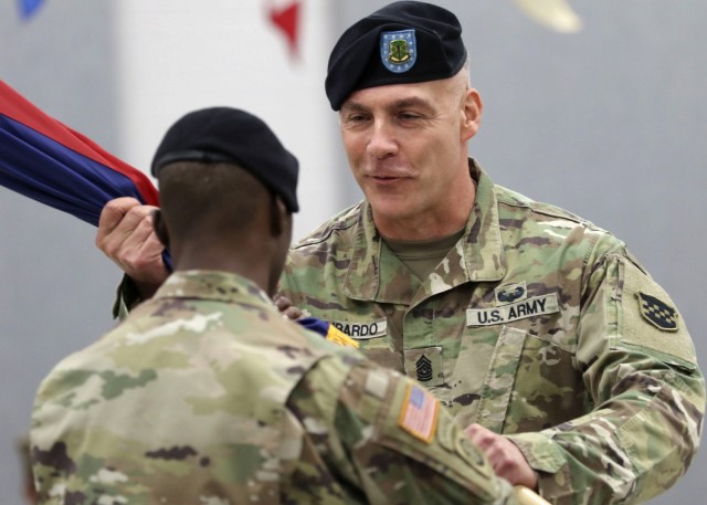 Command Sgt. Maj. Andrew Lombardo, the outgoing command sergeant major for the Army Reserve’s 99th Readiness Division, receives the colors during a change of responsibility ceremony Sept. 7, 2019. Lombardo, now the Army Reserve&#39;s senior...