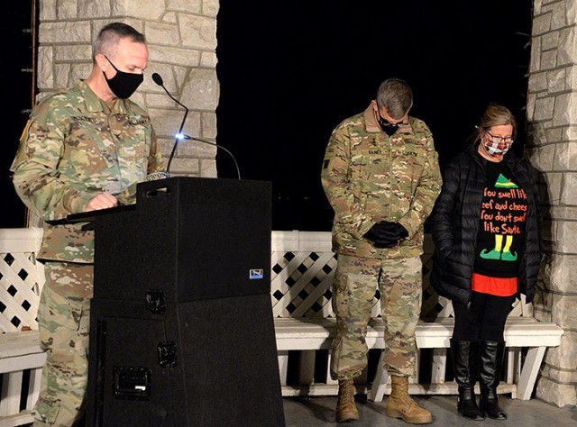 Combined Arms Center and Fort Leavenworth Commanding General Lt. Gen. James Rainey and Tracy Rainey bow their heads as Chaplain (Col.) Michael McDonald, Garrison chaplain, delivers the invocation during the annual lighting ceremony Dec. 4 at Zais...