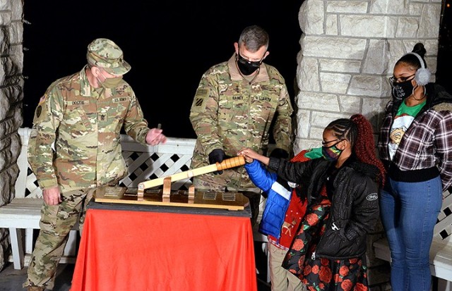 Combined Arms Center Command Sgt. Maj. Eric Dostie encourages the Wildy family — Jennifer Wildy, spouse of deployed soldier Sgt. 1st Class Damion Wildy, and their children 7-year-old Dahlia and 5-year-old Steffen — as they help Lt. Gen. James...