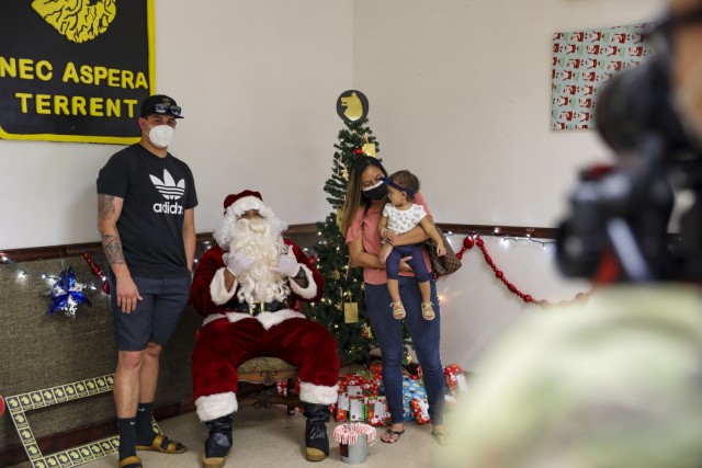 Soldiers and Families with 1st Battalion, 27th Infantry Regiment "Wolfhounds", 2nd Infantry Brigade Combat Team, 25th Infantry Division, hold a holiday party to wrap gifts to donate to the Holy Family Home orphanage on December 4, 2020 at Schofield Barracks, Hawaii. 1-27 IN and the Holy Family Home orphanage in Osaka, Japan, have an enduring relationship dating back to just after World War II, when Soldiers took up a collection for the orphanage during the holiday season in 1949. (U.S. Army photo by Staff Sgt. Thomas Calvert)