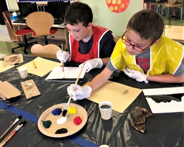 Children in Fort Bragg's Child and Youth Services gain hands-on experience with creative projects such as painting.