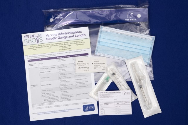 A display shows items that will be provided with COVID-19 vaccines at Operation Warp Speed headquarters in Washington, D.C. Nov. 13, 2020. Operation Warp Speed is an effort by several U.S. government components and public partnerships to...