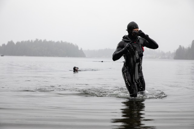 JOINT BASE LEWIS-MCCHORD, Wash. - A Green Beret with 1st Special Forces Group (Airborne) surfaces on American Lake, after completing the 1km swim event for the Menton Team Competition, Dec. 8, 2020. Green Berets with 1 SFG (A) were flown over the...