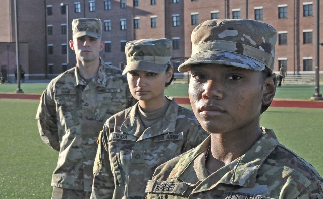 Pvt. Elizare Turner, Tango Company, 266th Quartermaster Battalion; Pfc. Victoria Huda, Bravo Co., 266th QM Bn.; and Pfc. Owen Doane, Bravo Co., 266th QM Bn., pose for pictures Dec. 3 near their barracks. The three volunteered for and earned teal ribbons as representatives of Students Against Sexual Harassment, a 23rd QM Brigade grassroots effort that trains students to be information conduits for the Army’s Sexual Harassment/Assault Response and Prevention program.