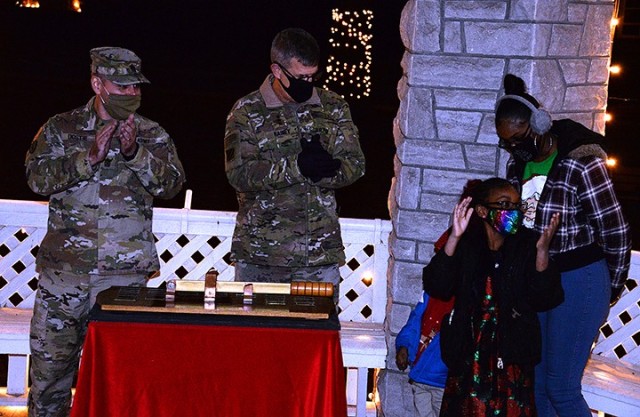 Combined Arms Center Command Sgt. Maj. Eric Dostie and CAC and Fort Leavenworth Commanding General Lt. Gen. James Rainey celebrate the lighting of Zais Park with the Wildy family — Jennifer Wildy, spouse of deployed soldier Sgt. 1st Class Damion...