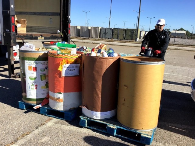 Barrels filled with donated food items from various units and organization across Fort Bragg during the Base Wide Food Drive are being loaded onto a truck to be delivered to local food banks.