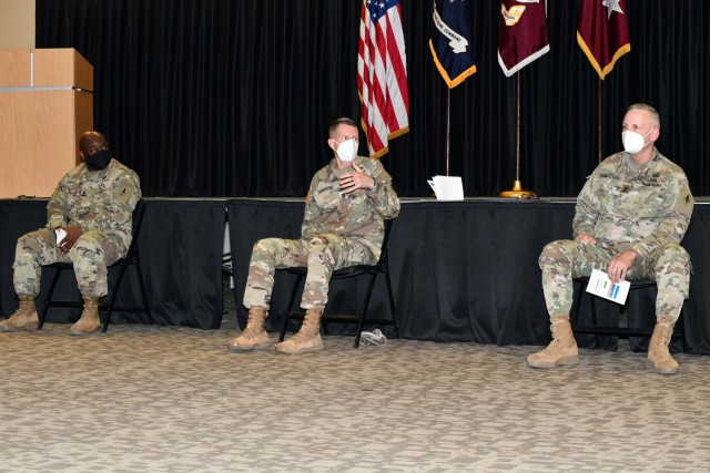 Cmd. Sgt. Maj. Clark Charpentier (center) answers a question on the Army Combat Fitness Test as Sgt. Maj. Larry White II and Maj. Gen. Dennis LeMaster look on.