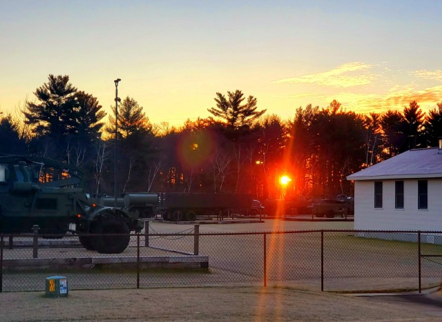 A frosty morning is slowly warmed with the rays of the sun glowing through the trees Dec. 10, 2020, at the Equipment Park in the historic Commemorative Area at Fort McCoy, Wis.  Morning temperatures in the 20s caused widespread frost. (U.S. Army...