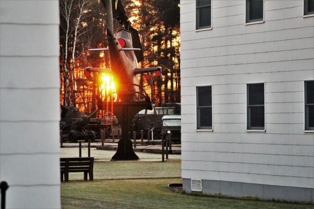 A frosty morning is slowly warmed with the rays of the sun glowing through the trees Dec. 10, 2020, at the Equipment Park in the historic Commemorative Area at Fort McCoy, Wis. Morning temperatures in the 20s caused widespread frost. (U.S. Army...