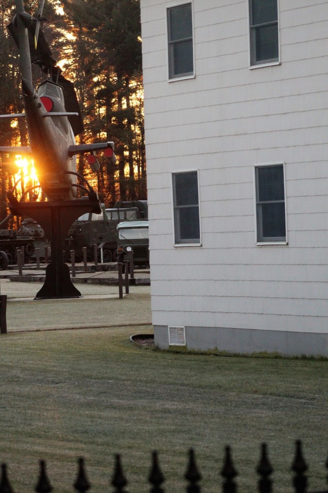A frosty morning is slowly warmed with the rays of the sun glowing through the trees Dec. 10, 2020, at the Equipment Park in the historic Commemorative Area at Fort McCoy, Wis. Morning temperatures in the 20s caused widespread frost. (U.S. Army...