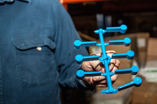 Preston Palmer, a pattern maker with Fort Jackson's Training Support Center, holds a set of dime washers, one of the many training aids his shop produces, Dec. 3.