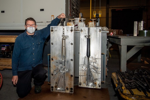 Preston Palmer, a pattern maker with Fort Jackson's Training Support Center, poses for a photo next to one of his molds Dec. 3.