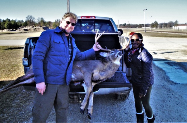 A pair of successful hunters stand next to a large whitetail buck Nov. 28, 2020, taken during the 2020 gun-deer season at Fort McCoy, Wis. Nearly 300 deer were harvested during the season, meeting deer management goals by post natural resources...