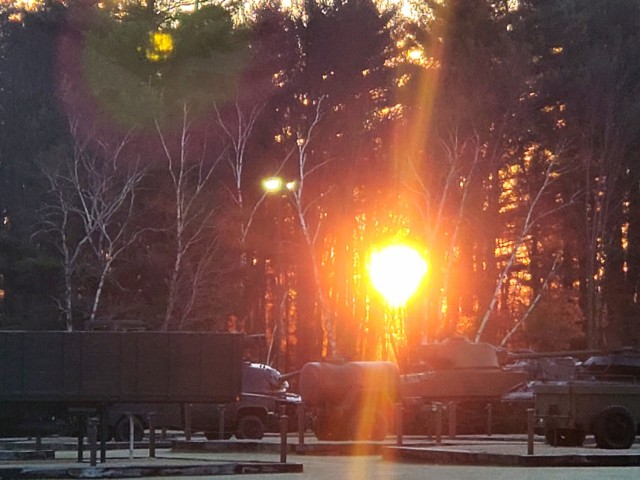 A frosty morning is slowly warmed with the rays of the sun glowing through the trees Dec. 10, 2020, at the Equipment Park in the historic Commemorative Area at Fort McCoy, Wis.  Morning temperatures in the 20s caused widespread frost. (U.S. Army...