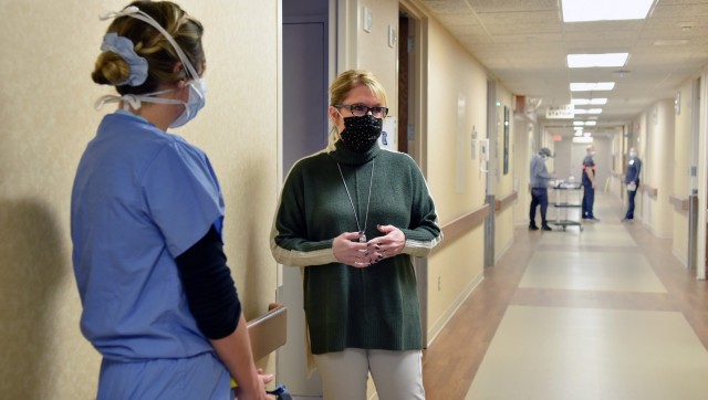 Karen Zimmerman, registered nurse and the Chief Nursing Officer at Trinity Hospital talks with members of the 59th Medical Wing, Lackland Air Force Base, Texas, about patient care in the COVID-19 wards, in Minot, N.D., Nov. 27, 2020. U.S. Northern...
