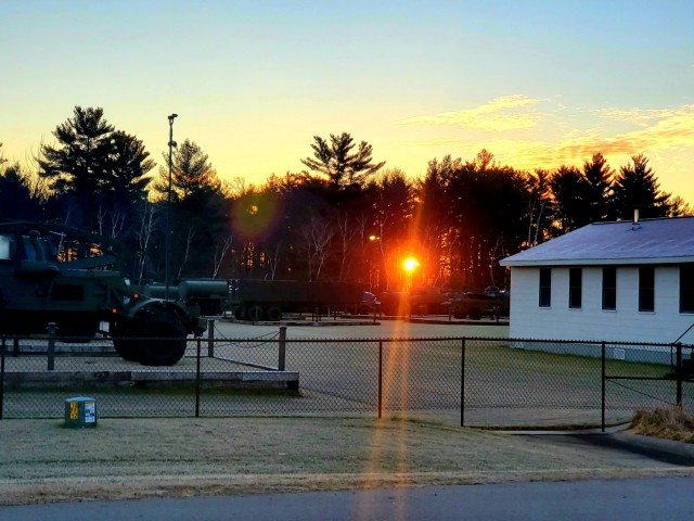 A frosty morning is slowly warmed with the rays of the sun glowing through the trees Dec. 10, 2020, at the Equipment Park in the historic Commemorative Area at Fort McCoy, Wis.  Morning temperatures in the 20s caused widespread frost. (U.S. Army...