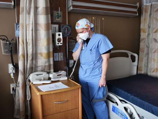 U.S. Air Force Capt. Cassady McEuen, a registered nurse assigned to the 959th Medical Group, Joint Base San Antonio-Fort Sam Houston, Texas, works on preparing a room for a patient at Trinity Hospital in Minot, N.D., Nov. 27, 2020. U.S. Northern...