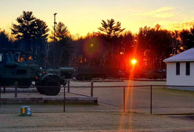 A frosty morning is slowly warmed with the rays of the sun glowing through the trees Dec. 10, 2020, at the Equipment Park in the historic Commemorative Area at Fort McCoy, Wis.  Morning temperatures in the 20s caused widespread frost. (U.S. Army...