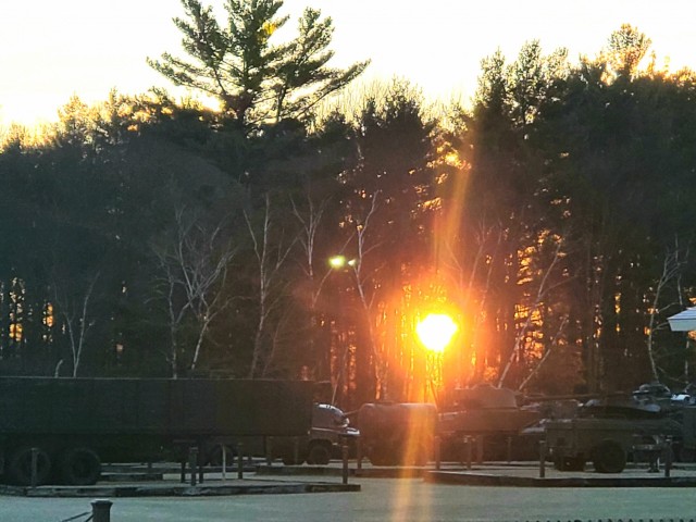 A frosty morning is slowly warmed with the rays of the sun glowing through the trees Dec. 10, 2020, at the Equipment Park in the historic Commemorative Area at Fort McCoy, Wis.  Morning temperatures in the 20s caused widespread frost. (U.S. Army...