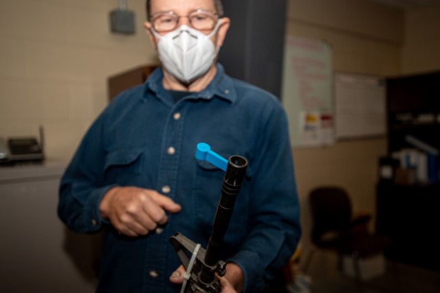 Preston Palmer, a pattern maker with Fort Jackson's Training Support Center, displays how to use the dime washer, one of the many training aids his shop produces, Dec. 3.