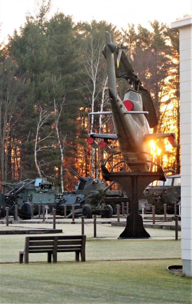 A frosty morning is slowly warmed with the rays of the sun glowing through the trees Dec. 10, 2020, at the Equipment Park in the historic Commemorative Area at Fort McCoy, Wis. Morning temperatures in the 20s caused widespread frost. (U.S. Army...