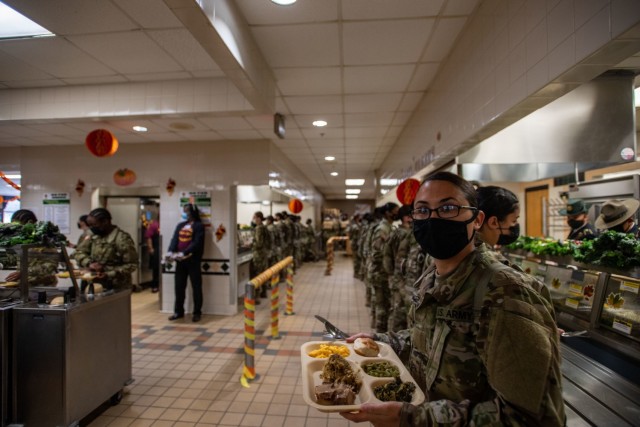 A trainee from 2nd Battalion, 39th Infantry Regiment carries her Thanksgiving meal Nov. 25.