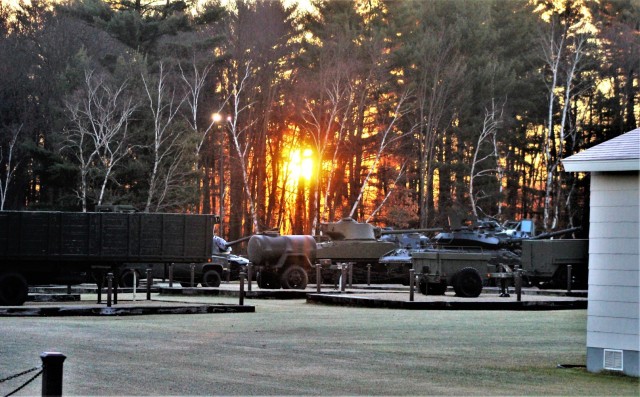 A frosty morning is slowly warmed with the rays of the sun glowing through the trees Dec. 10, 2020, at the Equipment Park in the historic Commemorative Area at Fort McCoy, Wis. Morning temperatures in the 20s caused widespread frost. (U.S. Army...
