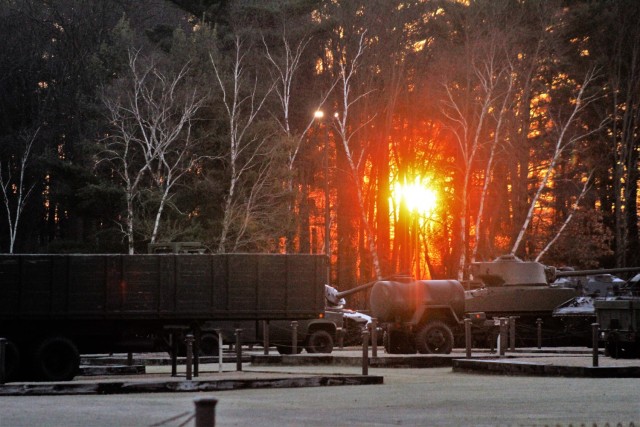 A frosty morning is slowly warmed with the rays of the sun glowing through the trees Dec. 10, 2020, at the Equipment Park in the historic Commemorative Area at Fort McCoy, Wis. Morning temperatures in the 20s caused widespread frost. (U.S. Army...