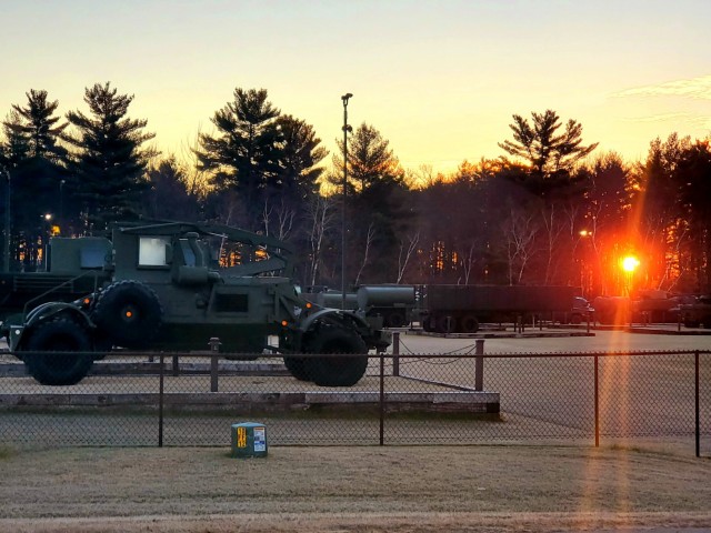 A frosty morning is slowly warmed with the rays of the sun glowing through the trees Dec. 10, 2020, at the Equipment Park in the historic Commemorative Area at Fort McCoy, Wis.  Morning temperatures in the 20s caused widespread frost. (U.S. Army...