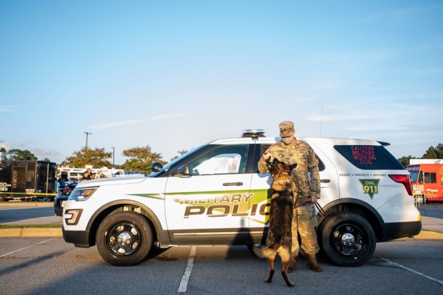 A military policeman plays with his military working dog during the National Night Out celebration earlier this year. The event helps communities get closer with law enforcement. Despite COVID-19 precautions the event was a hit and named best...