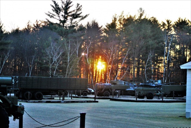A frosty morning is slowly warmed with the rays of the sun glowing through the trees Dec. 10, 2020, at the Equipment Park in the historic Commemorative Area at Fort McCoy, Wis. Morning temperatures in the 20s caused widespread frost. (U.S. Army...