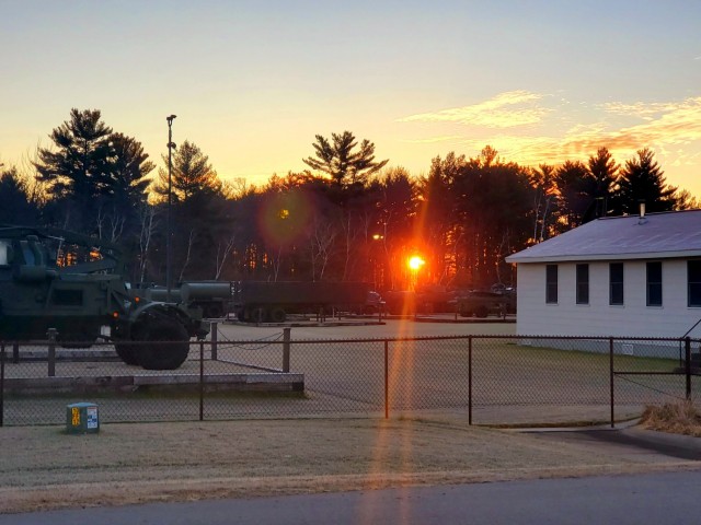 A frosty morning is slowly warmed with the rays of the sun glowing through the trees Dec. 10, 2020, at the Equipment Park in the historic Commemorative Area at Fort McCoy, Wis.  Morning temperatures in the 20s caused widespread frost. (U.S. Army...
