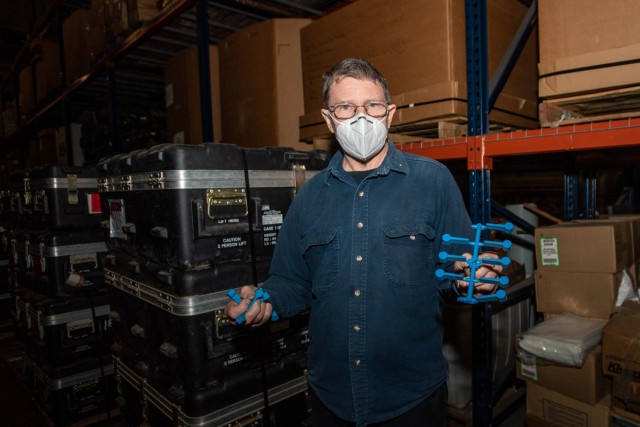 Preston Palmer, a pattern maker with Fort Jackson's Training Support Center, poses with a set of dime washers, one of the many training aids his shop produces, Dec. 3.