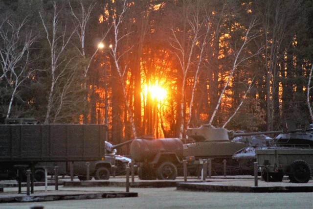A frosty morning is slowly warmed with the rays of the sun glowing through the trees Dec. 10, 2020, at the Equipment Park in the historic Commemorative Area at Fort McCoy, Wis. Morning temperatures in the 20s caused widespread frost. (U.S. Army...