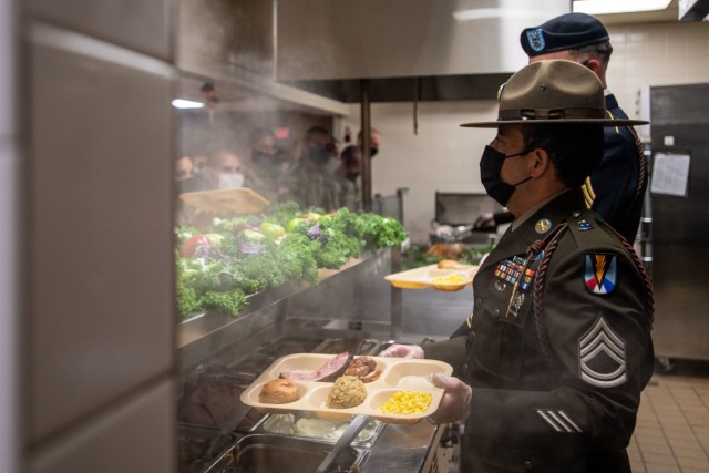 Noncommissioned officers from 2nd Battalion, 39th Infantry Regiment serve a Thanksgiving meal to trainees Nov. 25.