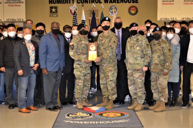 Leaders from the 403rd Army Field Support Brigade and the Army Field Support Battalion–Northeast Asia, join with battalion personal to display the 2020 Army Award for Maintenance Excellence that the unit received during a ceremony at Camp...