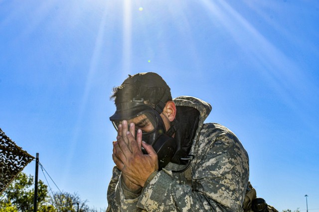 A Soldier clears and seals his gas mask while participating in the Expert Infantryman Badge/Expert Soldier Badge Qualification Course, November 25, 2020, at Fort Hood, TX. The EIB/ESB Qualification is being held by 2nd Armored Brigade Combat Team,...