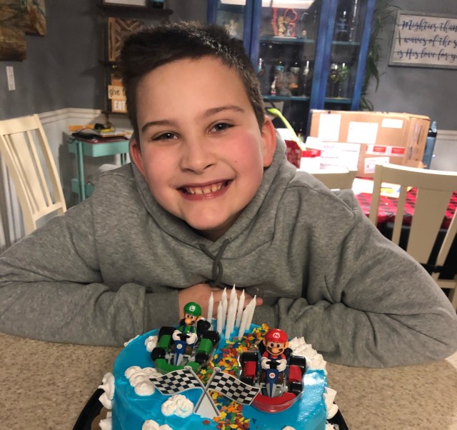 Victor Lamison, 11, smiles for a photo with his birthday cake in Nampa, Idaho, Nov. 29.