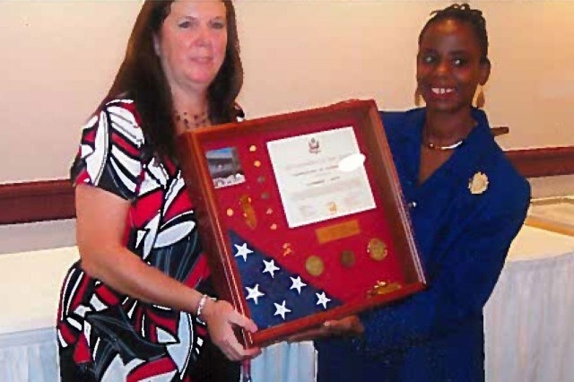 Joyce Allen (Right), Secretary of the General Staff Tank-automotive and Armaments Command, presents a retirement shadowbox to Kathy Giffin (Left) in 2008. 