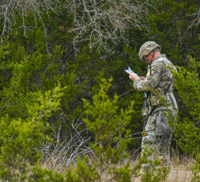 A Soldier with 2nd Armored Brigade Combat Team, 1st Cavalry Division, checks his map on a land navigation lane, while participating in the Expert Infantryman Badge/Expert Soldier Badge Qualification Course, November 25, 2020, at Fort Hood, TX. The...