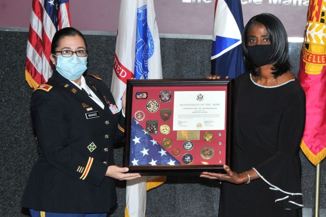 Col. Santee Vasquez (Left), Chief of Staff Tank-automotive and Armaments Command, presents Joyce Allen (Right), Secretary of the General Staff TACOM, with a Meritorious Civilian Service Medal at her retirement ceremony Dec. 9 at the Detroit...