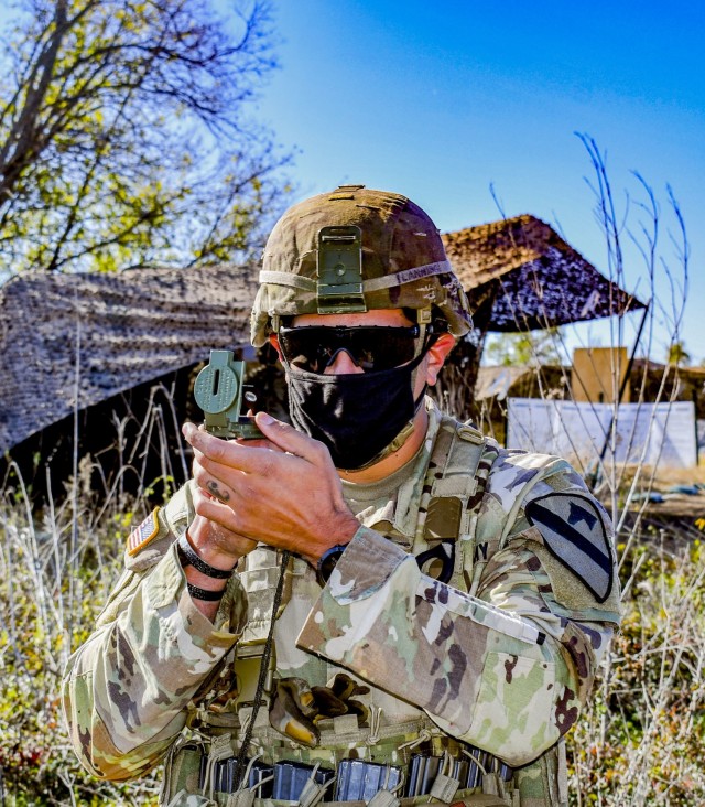 Army SSG Christopher Lanning, with 1st Battalion, 8th Cavalry Regiment, 2nd Brigade Armored Combat Team, 1st Cavalry Division, shoots an azimuth while participating in the Expert Infantryman Badge/Expert Soldier Badge Qualification Course,...