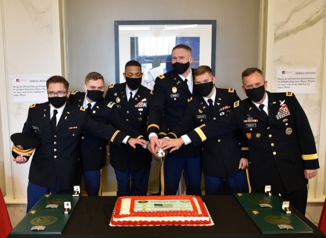 Lt. Gen. Daniel L. Karbler, right, commanding general, U.S. Army Space and Missile Defense Command, participates in a ceremonial cake cutting with four graduating University of Alabama ROTC cadets following their commissioning into the Army during...